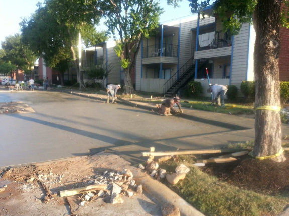 pouring and spreading concrete for parking lot